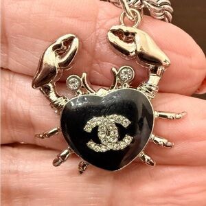 Chanel Silver-Tone stamped Crab in black
enamel & Chrystal
on 19" twist rope